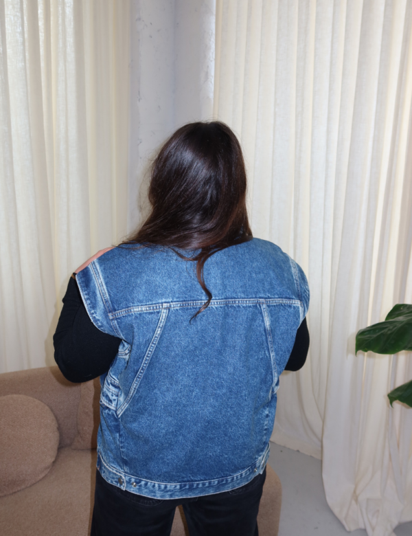 vue dos veste en jean bleu sans manches épaules structurées
